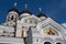 View of domes and facade decoration from below at Cathedral of St Aleksandr Nevsky