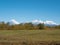 View of the domestic Kamchatka volcanoes against the background of the blue sky and autumn forest. Kamchatka Peninsula, Russia