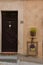 View of a door in front of an house in Spello town Umbria, Italy decorated with flowers and frames