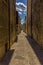 A view down a narrow alleyway at siesta time in the city of Gubbio, Italy