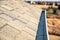 View down a roof gutter with clips and edge of shingles