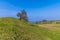 A view down the side of the eastern ramparts of the Iron Age Hill fort remains at Burrough Hill in Leicestershire, UK