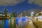 View down Yarra River towards Seafarers Bridge and lights of city buildings in long exposure