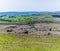 A view downhill over rocky outcrops on the final climb to the escarpment of Stanage Edge in the Peak District, UK