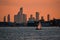 View of downtown Toronto skyline and a yacht against an orange