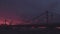 View at dramatic red and black night sky thunder storm. Lighting flash. Bridge. Stormy weather.