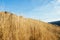 View through dried grass of lonely church in the middle of the hill