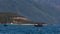 view of drifting along beach fishing boat against mountains