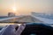 View of the driver hand on the steering wheel of the car while driving on a slippery snow covered road