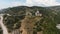 The view from the drone. Action. View of the beautiful green mountains next to the sea on which there is a temple, tall