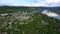 The view from the drone. Clip. Beautiful summer view of the blue lake, houses, mountains and blue sky.