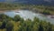 The view from the drone. Clip. Beautiful summer view of the blue lake, houses, mountains and blue sky.