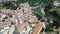 view from drone of fortified village of Besalu with Fluvia river and medieval arched bridge, Spain