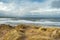 View from a dune on Atlantic ocean and beautiful cloudy sky, Strandhill town county Sligo, Ireland. Nobody