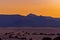 View of the dunes of Corralejo and silhouetted hills at sunset on the Canary Island of Fuerteventura, Spain