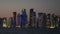 View at dusk across the water to illuminated downtown, Doha