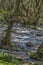 View of DÃƒo river, with trees, rocks and vegetation on the banks, reflections in the water and bright colors