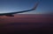 View of the earth from an airplane window from a height of 10,000 meters above the clouds illuminated