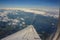 View of the earth from the airplane window. The wing of the plan