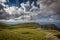 View from the edge of Rax plateau, with green, grassy meadow and blue cloudy sky