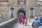View at the Edinburgh Castle front facade, detail of walls medieval fortress principal gate, and tourists walking