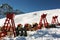 A view of elevated chairs and lounges in the snow covered landscape and mountains in St Moritz Switzerland in the alps