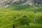 View on the elevator, ski lifts for the pass, cable car, Sella massif green hills. Dolomites, Italy, Beautiful sunny summer day,