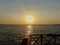 View of the embankment, a beautiful sunset on the sea and the ships on the horizon