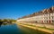 View of embankment in Besancon with tram on a bridge