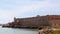 View of the embankment and the medieval fortress, Mandraki Harbour, Rhodes, Greece