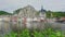 View at the embankment of Meuse river with multicolored houses and church of Our Lady Assumption in Dinant - Belgium