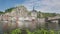 View at the embankment of Meuse river with multicolored houses and church of Our Lady Assumption in Dinant - Belgium