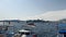 View of the embankment of a resort town in Turkey with boats moored at the pier, palm trees overlooking the mountains