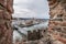 View through an embrasure in the castle wall of the fortress Feste Oberhaus near the three rivers city Passau with view on the cit