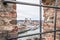 View through an embrasure in the castle wall of the fortress Feste Oberhaus near the three rivers city Passau with view on the cit