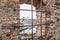 View through an embrasure in the castle wall of the fortress Feste Oberhaus near the three rivers city Passau with view on the cit