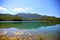 View of the emerald lake nestled among the green mountains reflected in the water, montagna spaccata, Alfedena, Abruzzo, Italy