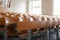 View on empty auditorium at university with wooden chairs and banks and large.