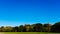 View of empty Great Lawn of Central Park under clear blue sky, in New York City, USA