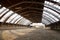 View in an empty indoor riding hall center for horses and riders. The riding school is suitable for dressage and jumping horses