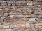 View of empty, old white, pink and grey brick wall background with copy space. A deteriorating old brick wall outdoors