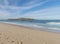 View of empty Praia da Ilha do Pessegueiro sand beach with with long exposure blurred ocean waves and Fort of