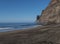 View of empty sand beach Playa de Guigui with rocky cliffs in west part of the Gran Canaria island, accessible only on