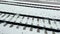 view of the empty snow-covered railway from the train window on a snowy winter day, the railways cross at high speed