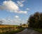 View of English countryside Winter, rural roadway, cloudy blue sky