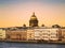 View of the English embankment of the Neva river and the dome of St. Isaac`s Cathedral at sunset. Saint Petersburg