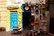 View on entrance arabian shop with handmade colorful painted clay plates hanging on wall in bright sun and shade , Medina of
