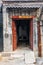 A view of an entrance of a courtyard in a traditional Beijing H