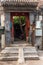 A view of an entrance of a courtyard in a traditional Beijing H