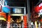 View of entrance gate to Trans Studio amusement park with crowd of people at ticket admission.